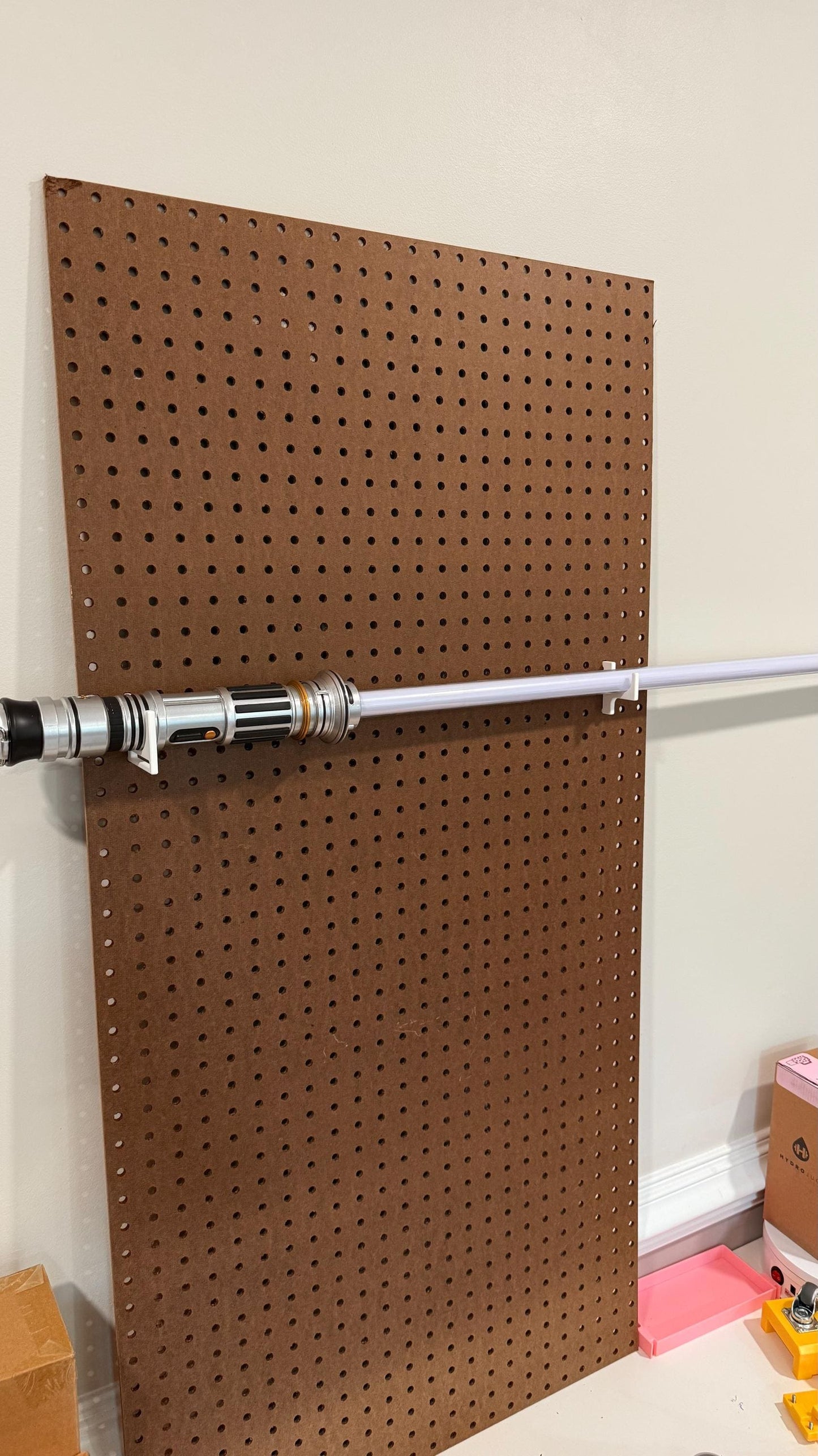Two-piece Star Wars lightsaber holder for standard pegboard