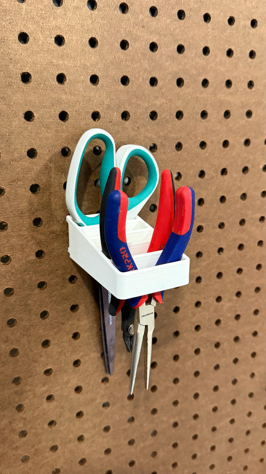 Pegboard scissor holder with pliers and pens organized